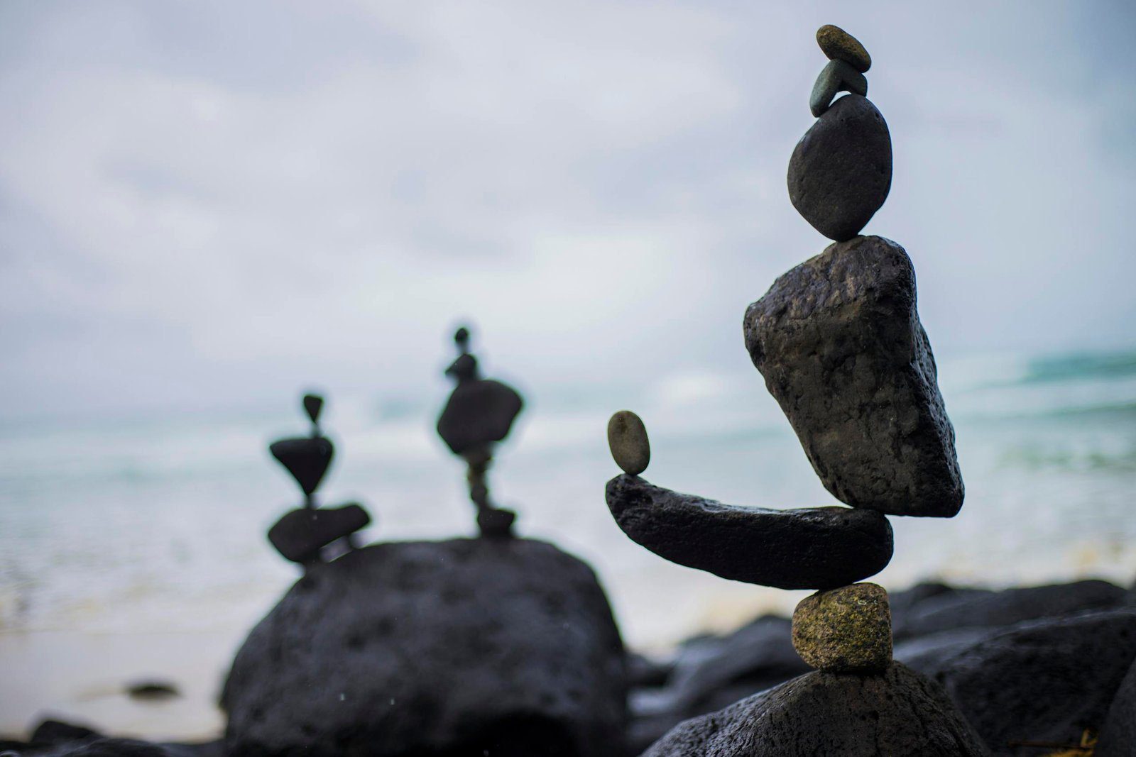 Artistic rock balancing on a serene beach in Fingal Head, NSW, Australia.