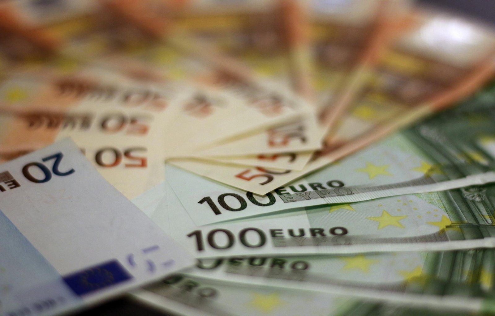 Close-up of various euro banknotes fanned out, symbolizing wealth and financial success.